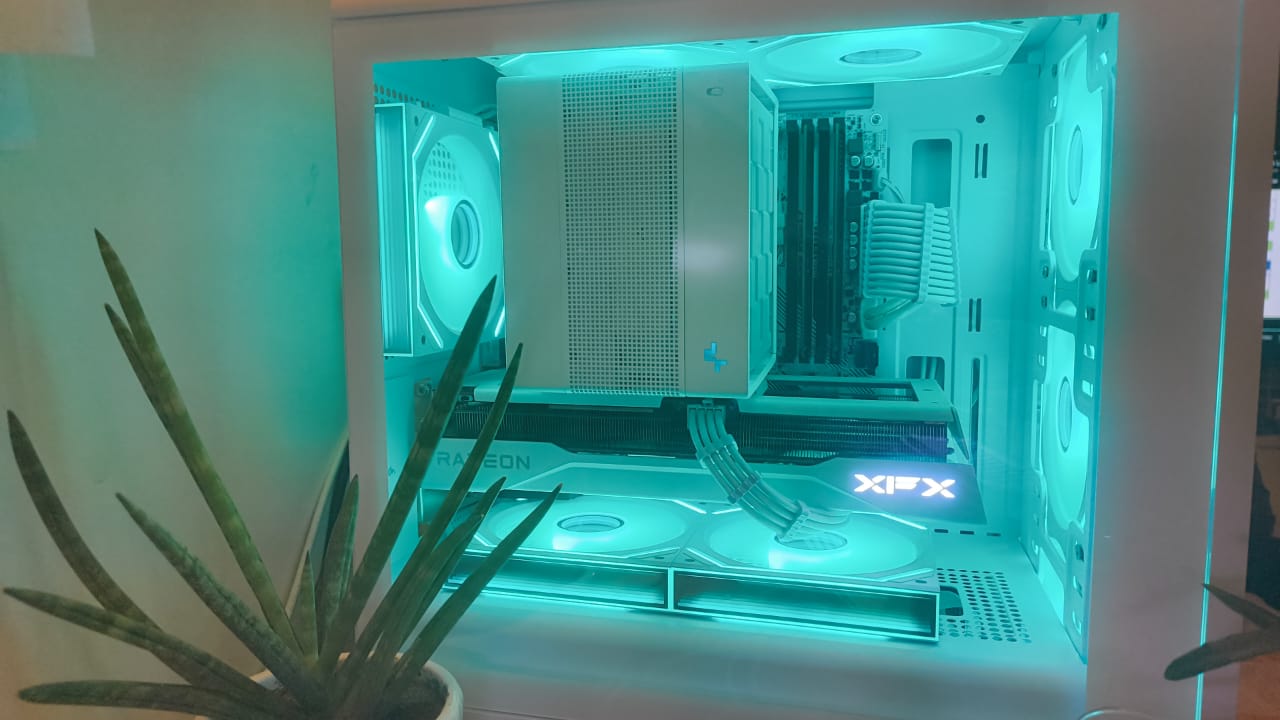 White custom PC interior with teal RGB lighting, XFX Radeon graphics card, and full component view